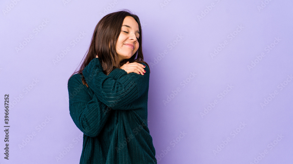 Young mixed race hispanic woman isolated hugs, smiling carefree and happy. Young mixed race hispanic woman isolated hugs, smiling carefree and happy.