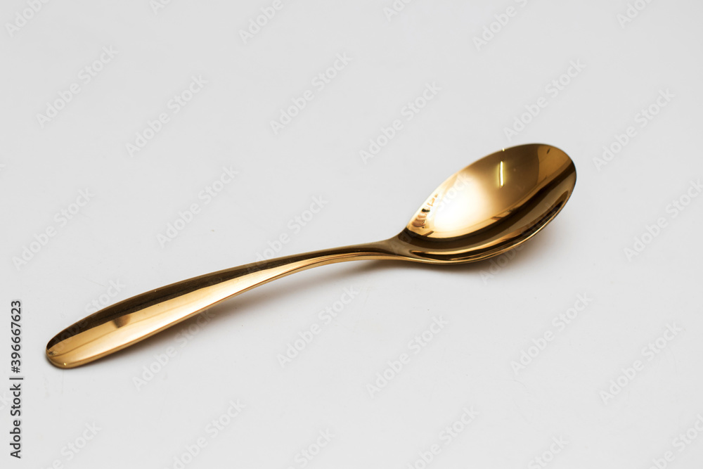 Top view of golden spoon and fork isolated white background. Top view of golden spoon and fork isolated white background.