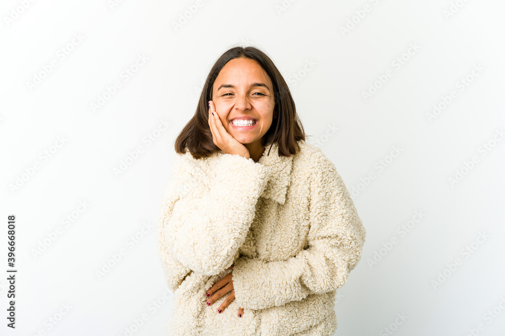 Young mixed race woman laughs happily and has fun keeping hands on stomach. Young mixed race woman laughs happily and has fun keeping hands on stomach.