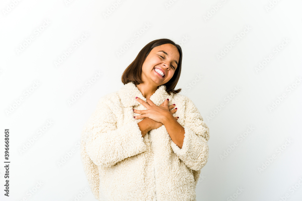 Young mixed race woman laughing keeping hands on heart, concept of happiness. Young mixed race woman laughing keeping hands on heart, concept of happiness.