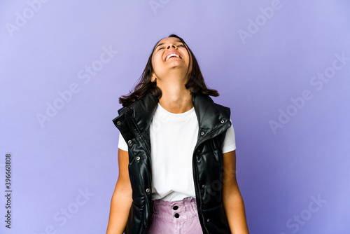 Young mixed race woman relaxed and happy laughing, neck stretched showing teeth.