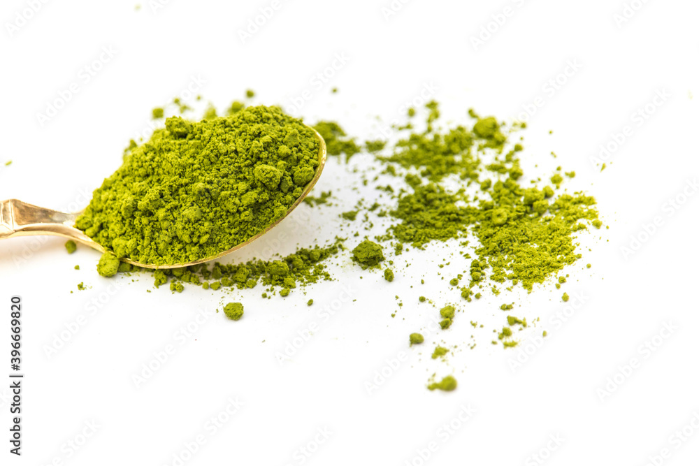 Japanese Matcha Tea Powder on Golden Spoon Isolated White Background. Japanese Matcha Tea Powder on Golden Spoon Isolated White Background.