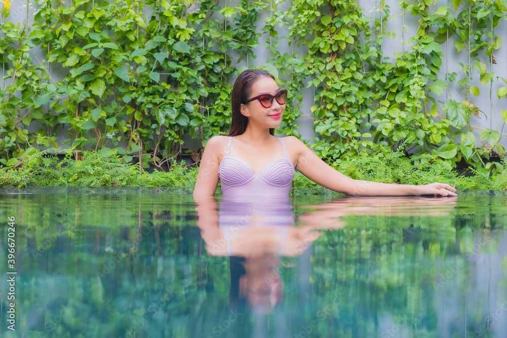 Fototapeta premium Portrait beautiful young asian woman relax smile leisure around outdoor swimming pool