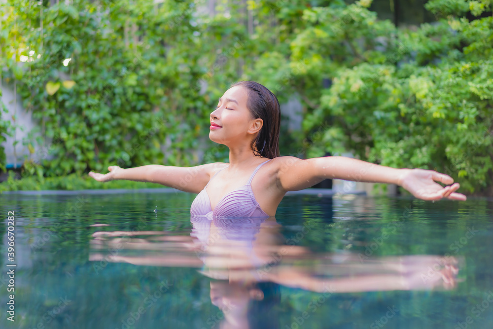 Fototapeta premium Portrait beautiful young asian woman relax smile leisure around outdoor swimming pool