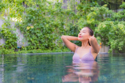 Portrait beautiful young asian woman relax smile leisure around outdoor swimming pool