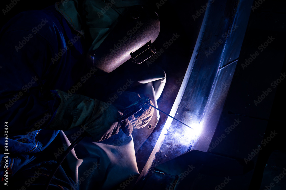 Welder is assembling the workpiece by process shielded metal arc