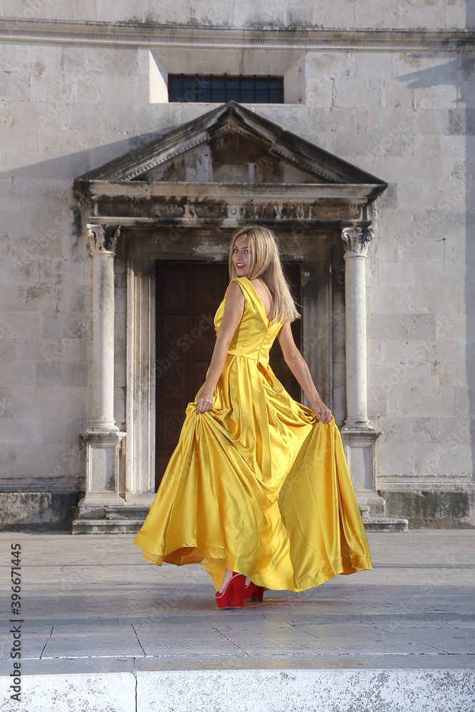 Women in yellow dresses in the square