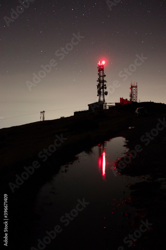 Antennas in front of a puddle in high mountain