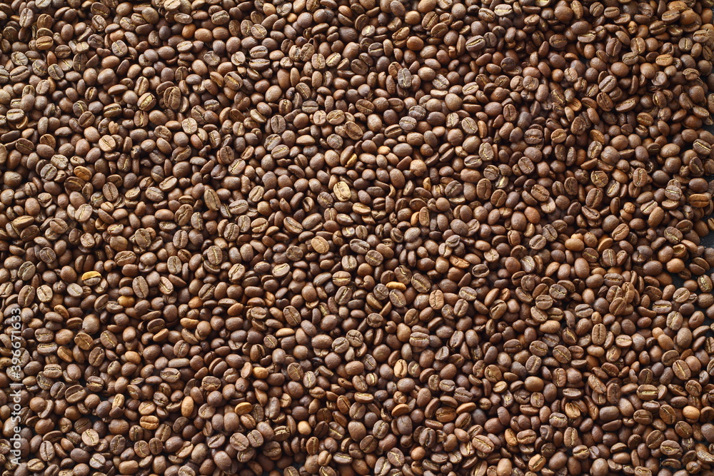 Coffee beans texture or coffee beans background. Brown roasted coffee beans. Closeup shot of coffee beans. Coffee beans texture or coffee beans background. Brown roasted coffee beans. Closeup shot of coffee beans.