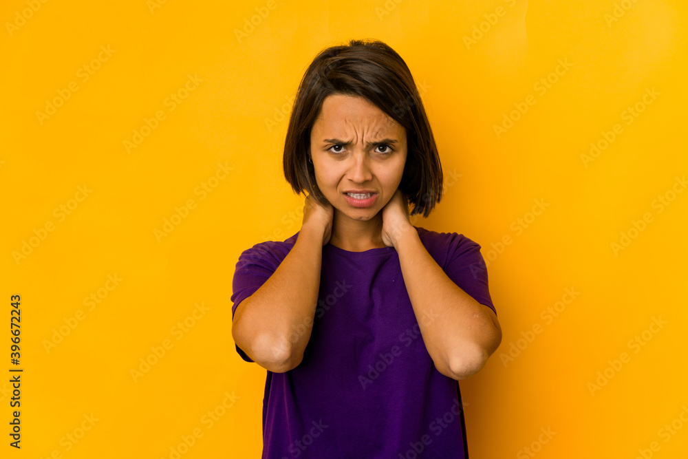 Young hispanic woman isolated on yellow touching back of head, thinking and making a choice. Young hispanic woman isolated on yellow touching back of head, thinking and making a choice.