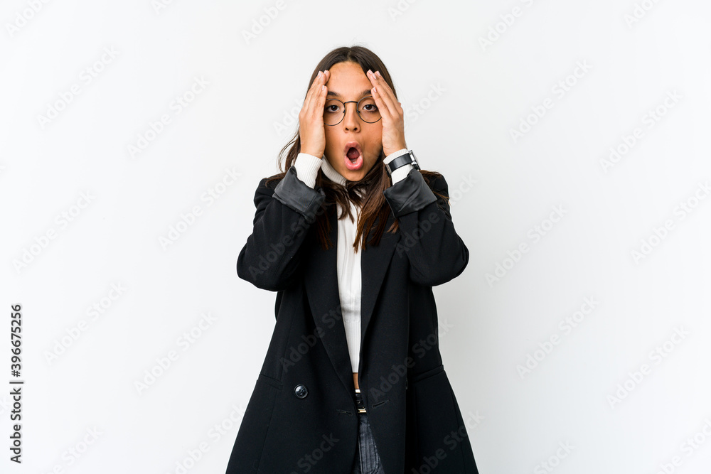 Young mixed race business woman isolated on white background having fun covering half of face with palm. Young mixed race business woman isolated on white background having fun covering half of face with palm.