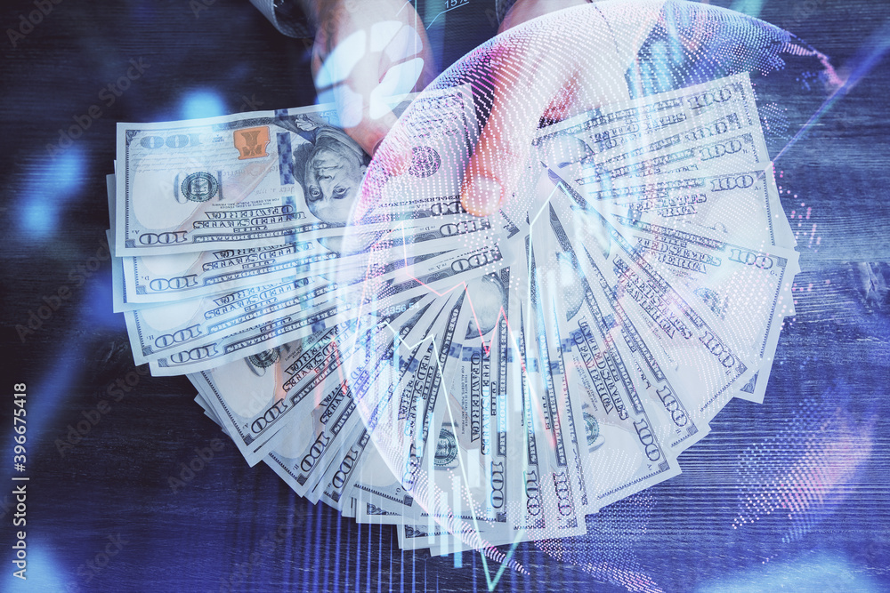 Multi exposure of financial graph drawing hologram and USA dollars bills and man hands. Analysis concept. Multi exposure of financial graph drawing hologram and USA dollars bills and man hands. Analysis concept.
