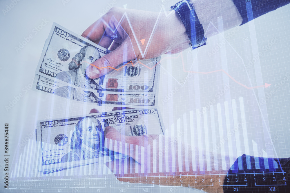 Multi exposure of financial graph drawing hologram and USA dollars bills and man hands. Analysis concept. Multi exposure of financial graph drawing hologram and USA dollars bills and man hands. Analysis concept.