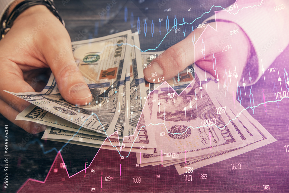 Multi exposure of financial graph drawing hologram and USA dollars bills and man hands. Analysis concept. Multi exposure of financial graph drawing hologram and USA dollars bills and man hands. Analysis concept.