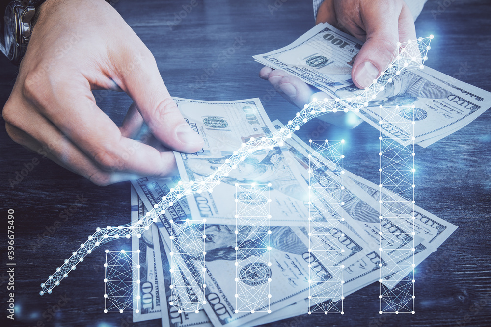 Multi exposure of financial graph drawing hologram and USA dollars bills and man hands. Analysis concept. Multi exposure of financial graph drawing hologram and USA dollars bills and man hands. Analysis concept.