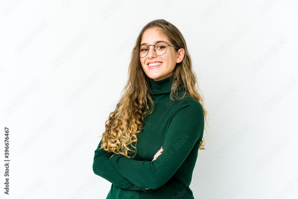 Young caucasian woman who feels confident, crossing arms with determination. Young caucasian woman who feels confident, crossing arms with determination.