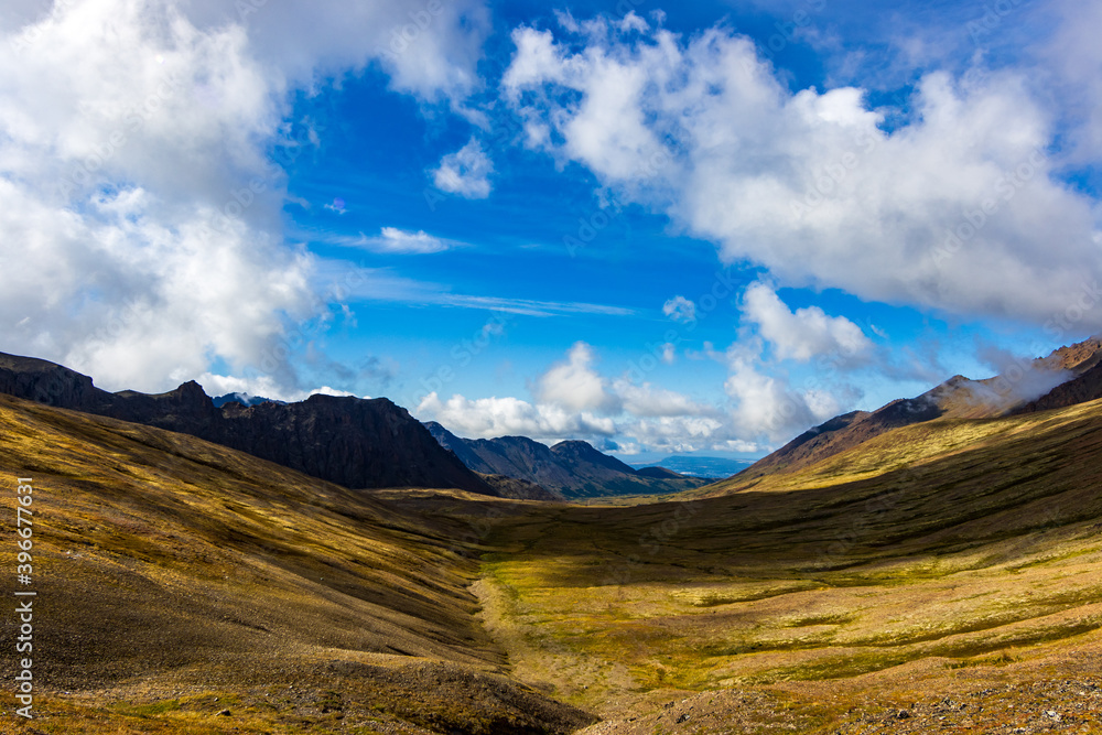 Panorama of Hidden Valley, a beautiful, high-altitude, glacial valley in the Chugach Mountains, Alaska.  The valley is above tree line, and is covered in alpine tundra and lowbush blueberry bushes.