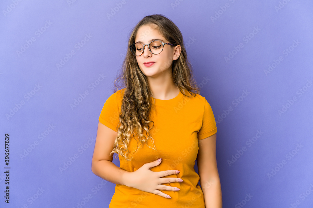 Young caucasian cute woman touches tummy, smiles gently, eating and satisfaction concept. Young caucasian cute woman touches tummy, smiles gently, eating and satisfaction concept.