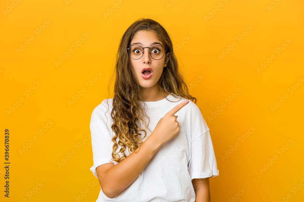 Young caucasian woman pointing to the side Young caucasian woman pointing to the side