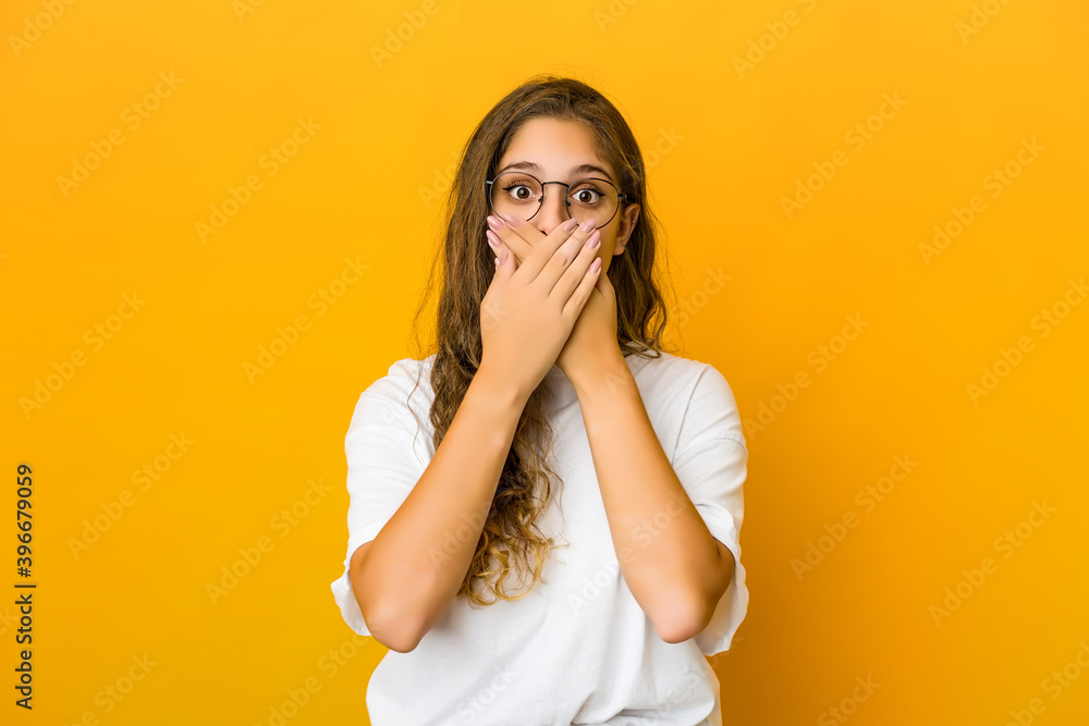 Young caucasian woman shocked covering mouth with hands. Young caucasian woman shocked covering mouth with hands.