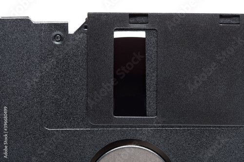 floppy diskette in a black square plastic case with open magnetic disk, obsolete computer technology device memory carrier 90s isolated on white background, close up view, nobody.