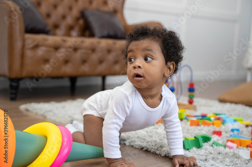 Tableau sur toile Happy African American Little baby boy crawling and looking for some thing to le