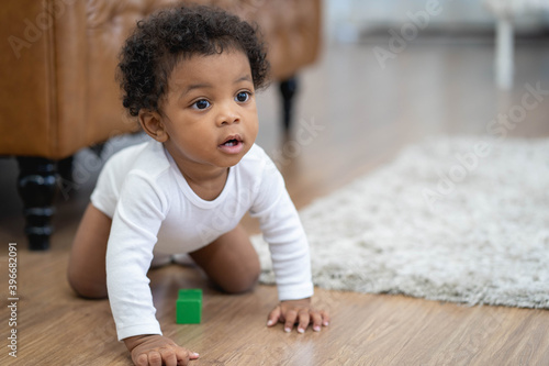 Happy African American Little baby boy crawling and looking for some thing to learn