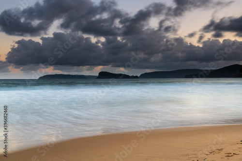 Cloudy sunset seascape with waves