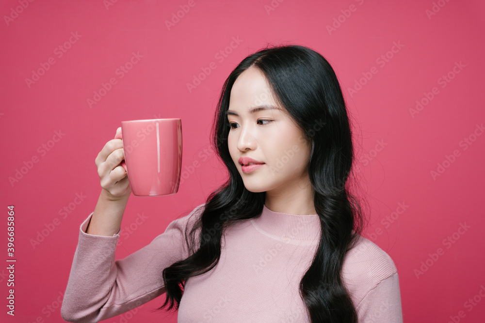 Portrait of asian woman holding coffee cup isolate on pink background. Portrait of asian woman holding coffee cup isolate on pink background.