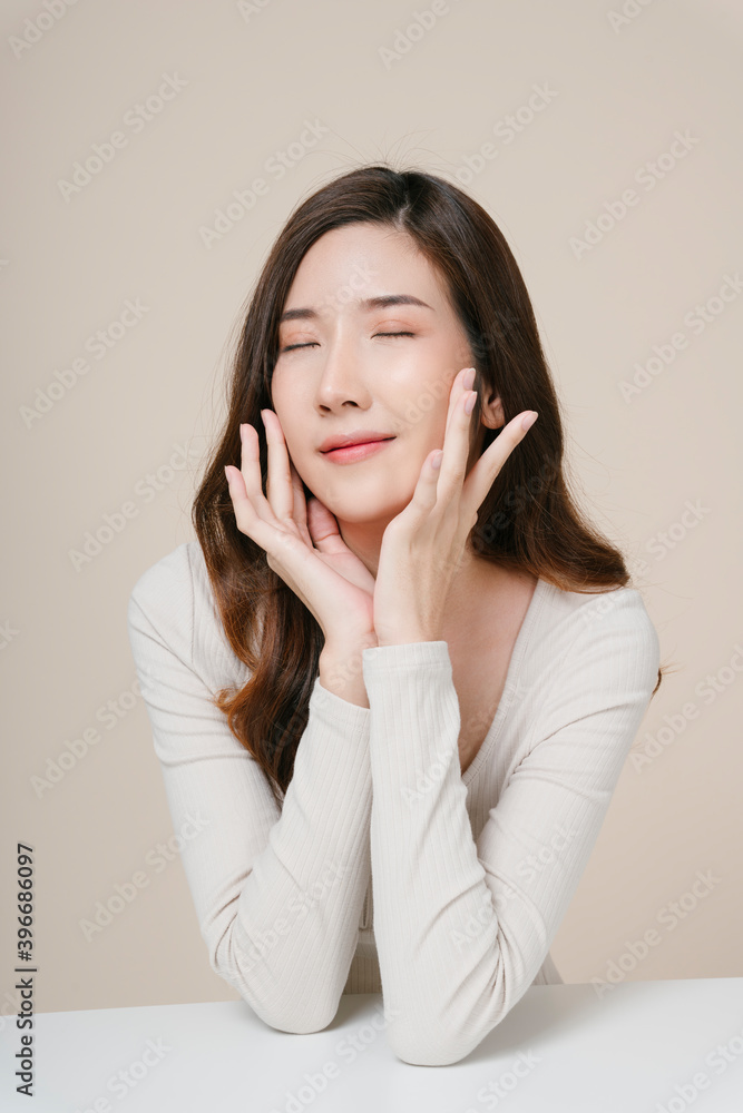 Portrait of beautiful young asian woman long dark hair isolate on beige background. Skincare concept. Portrait of beautiful young asian woman long dark hair isolate on beige background. Skincare concept.