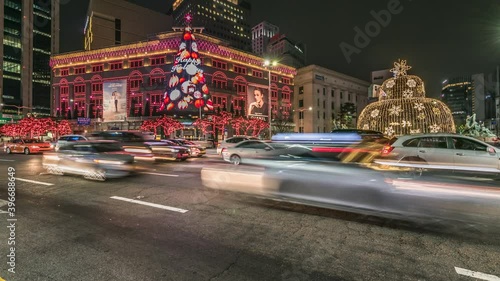 Time lapse SEOUL, South Korea - December 2, 2018: Beautiful Christmas lights in Myeongdong, traffic on shopping streets at night, Seoul, South Korea .Zoom in.
