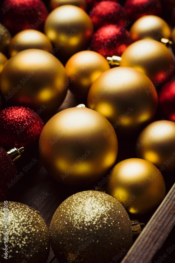 Red and golden christmas balls on the rustic wooden background. Selective focus.
Red and golden christmas balls on the rustic wooden background. Selective focus.