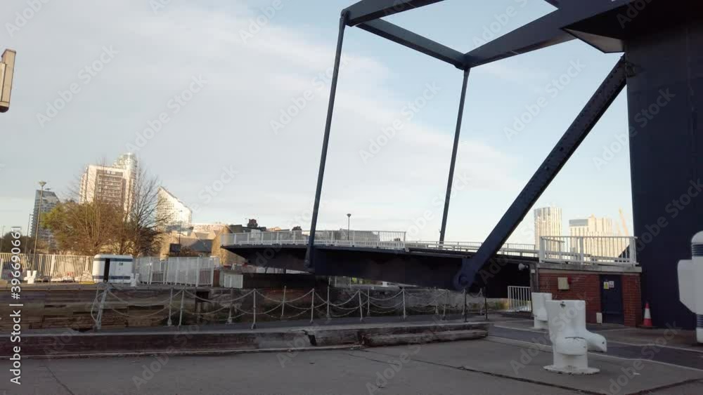 Rising Drawbridge called The Blue Bridge in Isle of Dogs, London, UK Rising Drawbridge called The Blue Bridge in Isle of Dogs, London, UK