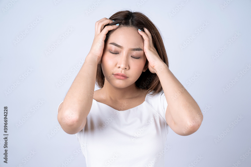 Beautiful young asian touching her temples feeling stress, Isolated on white background. Beautiful young asian touching her temples feeling stress, Isolated on white background.