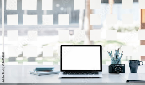 Wallpaper Mural Mockup blank screen laptop with stationary on white top table. Torontodigital.ca