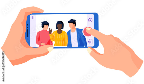 Men and african american girl standing side by side. Woman with phone in hands is recording a video massage from people and smiling. Man and woman are broadcasting online with using a phone