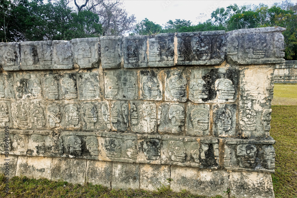 Details of the architecture of the ancient Mayan city of Chichen Itza. Skull platform. On a stone pedestal, along the perimeter, images of various human skulls are carved in rows. UNESCO. Mexico.