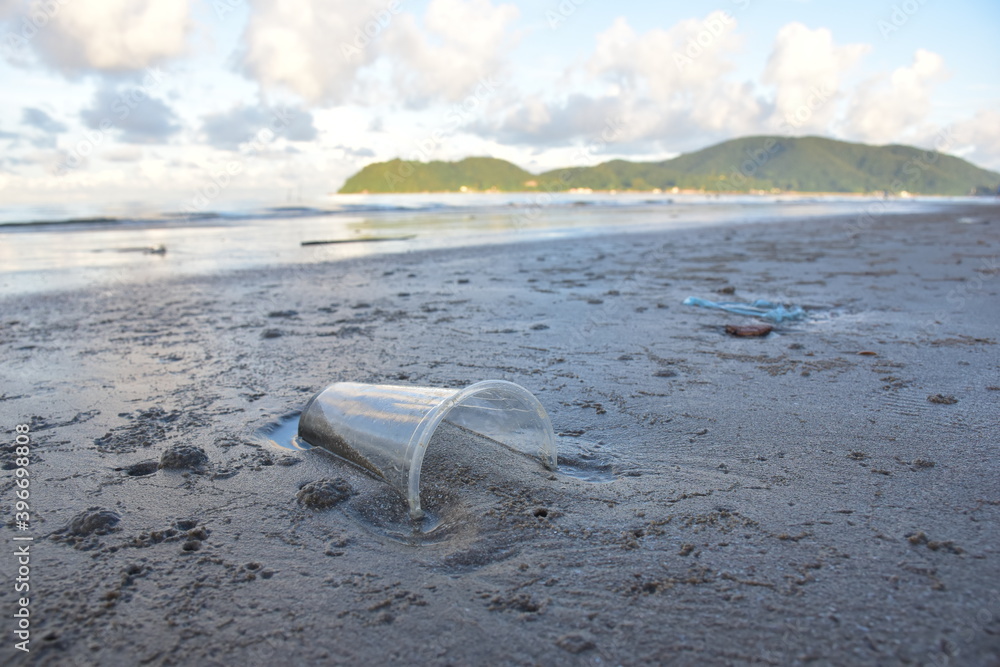 Closeup of Plastic waste on the beach Global problem of Environmental pollution concept with copy space the background in Thailand. Closeup of Plastic waste on the beach Global problem of Environmental pollution concept with copy space the background in Thailand.