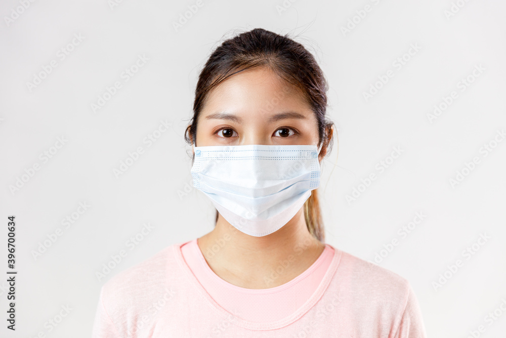 Asia woman wearing an anti virus protection mask to prevent others from corona COVID-19 on white background
Asia woman wearing an anti virus protection mask to prevent others from corona COVID-19 on white background