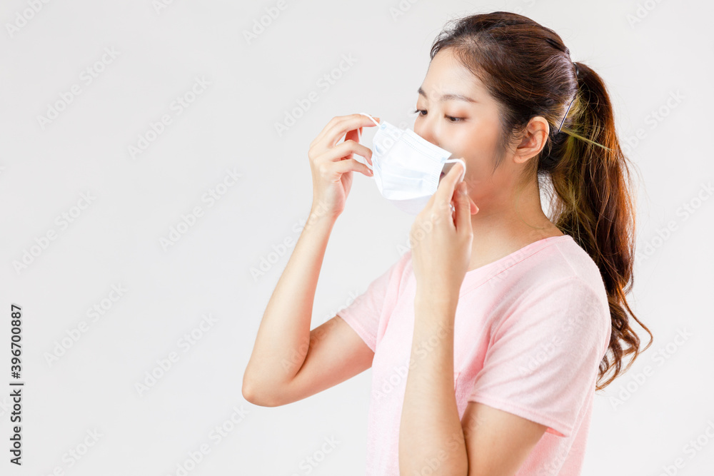 Asia woman wearing an anti virus protection mask to prevent others from corona COVID-19 on white background
Asia woman wearing an anti virus protection mask to prevent others from corona COVID-19 on white background