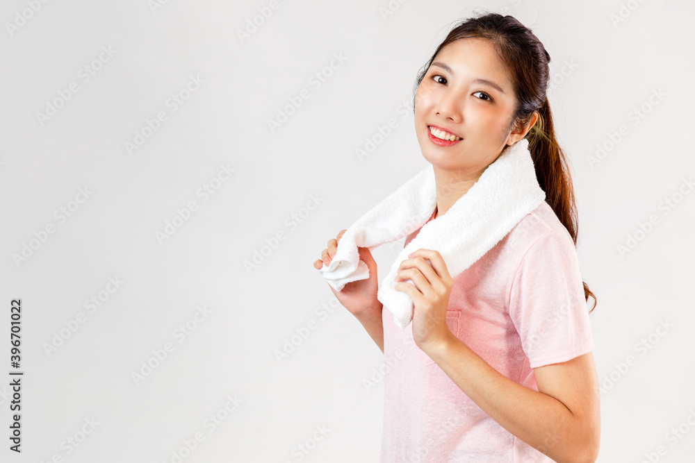 Asian woman holds a towel around her neck after exercising on white background Asian woman holds a towel around her neck after exercising on white background