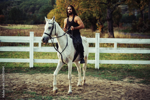 Romantic man lover riding horses. Bearded man on horse. Summer concept. Countryside cowboy.