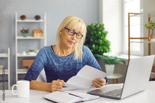 Cuadro en lienzo Sad senior lady reading utility bill, bank account balance notification or novel