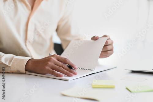 Cropped shot of businessman is taking note at his workplace in modern office.