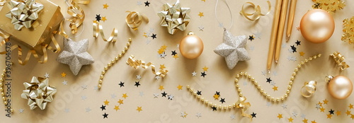 Christmas background banner. New Year decorations in gold colors on gold back...