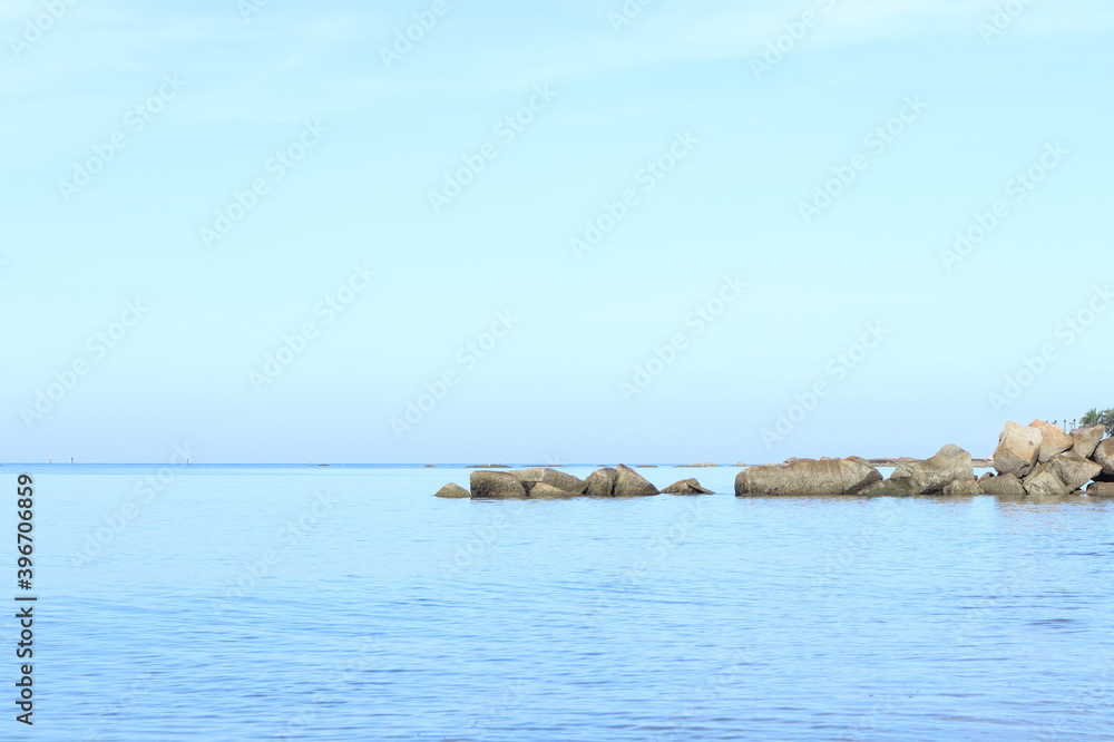 the blue sky in the morning at the beach and group of rocks during summer holiday at Pattaya beach , Thailand