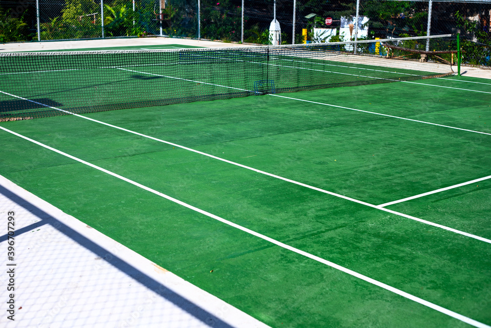 Empty tennis court under sun, sport field photo. Summer sport and active lifestyle concept. Healthy outdoor activity. Public park sport field. Open playground