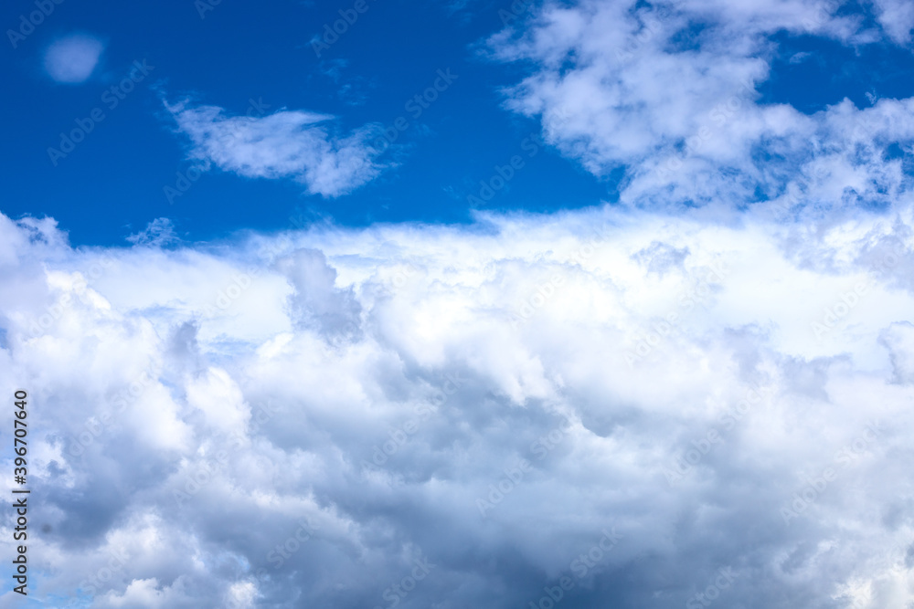 White fluffy cloud on azure blue sky. Rain weather or cyclone formation. Abstract natural photo. Cotton softness concept. Zen or relax cover template. Cloudy sky overcast