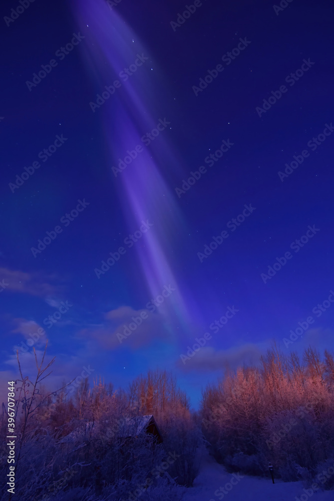 A pastel aurora borealis hovers over a snowy Alaska landscape as daybreak brightens the sky. A pastel aurora borealis hovers over a snowy Alaska landscape as daybreak brightens the sky.