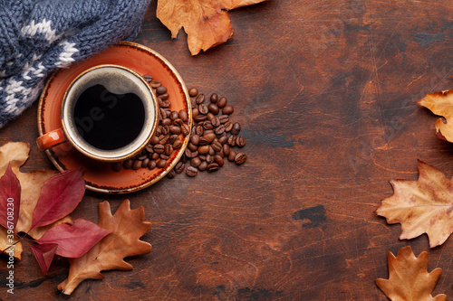 Coffee cup and autumn leaves